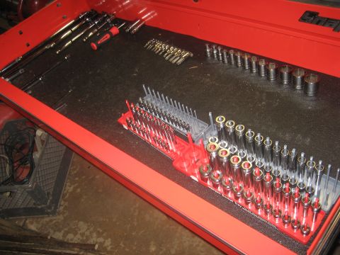2010 Chevrolet Apache - A red tool chest drawer is organized with various sockets, wrenches, and drill bits.