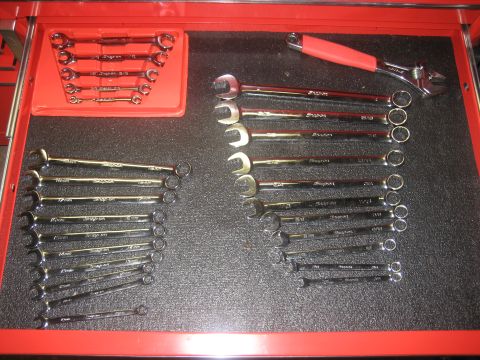 2010 Chevrolet Apache - A collection of wrenches and an adjustable wrench are neatly organized in a red tool drawer.