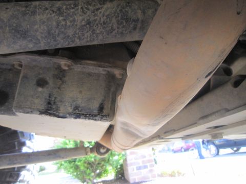 2008 Jeep Wrangler - Undercarriage view of a vehicle, focusing on suspension and exhaust system parts.