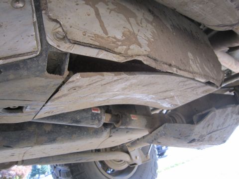 2008 Jeep Wrangler - The undercarriage of an off-road vehicle, protective skid plates and drivetrain components.