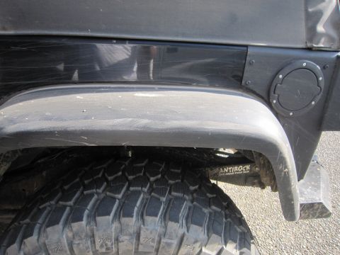 2008 Jeep Wrangler - Close-up of a Jeep Wrangler's rear fender, showing the tire and fuel door. The sway bar is labeled.