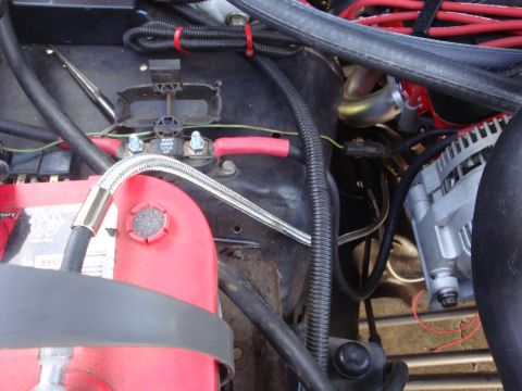 1989 Ford Bronco - Detail shot of engine bay components, including battery terminals and wiring.