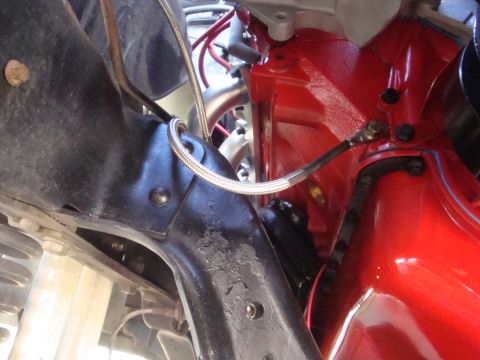 1989 Ford Bronco - Close-up view of engine components and suspension parts in a vehicle's engine bay.