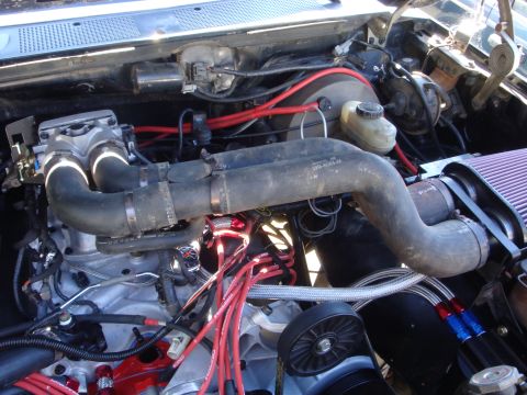 1989 Ford Bronco - Close-up view of a modified V8 engine bay, showing intake manifold and spark plug wires.