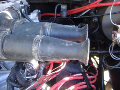 1989 Ford Bronco - Engine bay detail showing a dual intake manifold and associated wiring.