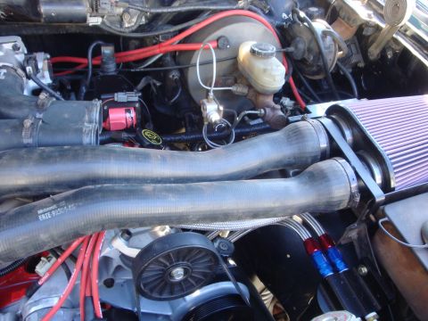 1989 Ford Bronco - Close-up view of an engine bay, showing various hoses, wiring, and engine components.