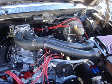 1989 Ford Bronco - Close-up view of a modified engine bay, showing various components and wiring.