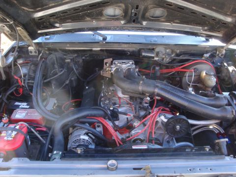 1989 Ford Bronco - The engine bay of a vehicle, showing the V8 engine and various components.