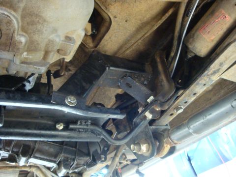 1989 Ford Bronco - A close-up view of the underside of a vehicle, showing mechanical parts and suspension.