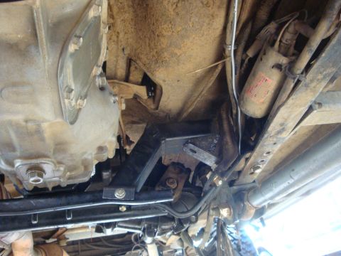 1989 Ford Bronco - Underside view of a vehicle's drivetrain and chassis components, with visible signs of wear and dirt.