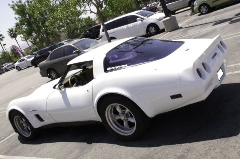 2006 Cadillac STS - This white Chevrolet Corvette C3 coupe is parked in a lot with other vehicles.