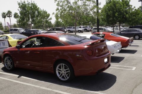 2006 Cadillac STS - A red coupe is parked in a lot with other vehicles visible in the background.