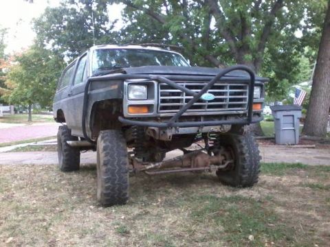 1986 Ford Bronco - This lifted Ford Bronco features a prominent brush guard and off-road tires.
