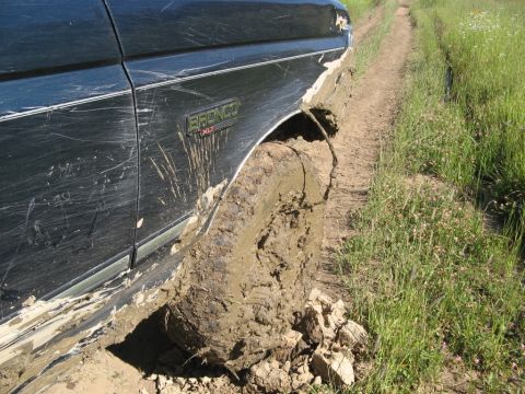 1995 Ford Bronco - This 1995 Ford Bronco is deeply mired in mud on a narrow, overgrown trail.