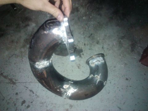 1995 Ford Probe - Custom exhaust pipe with welded flanges, likely for a modified vehicle.