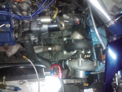 1995 Ford Probe - Close-up view of a modified engine bay a turbocharger and custom plumbing.