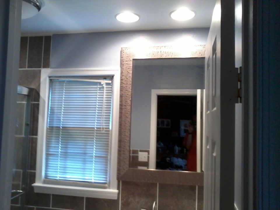 Bathroom interior with window blinds, mirror, tile, and recessed lighting