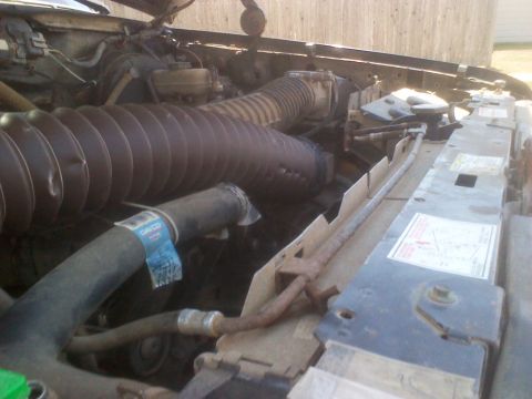 1995 Ford Bronco - Close-up view of the engine bay, highlighting the air intake system and radiator components. Some text is visible on the hose and radiator.