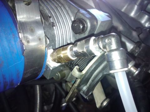 1995 Ford Probe - Close-up view of an engine component a blue hose and various metal fittings, with a SuperMotors.net watermark visible.