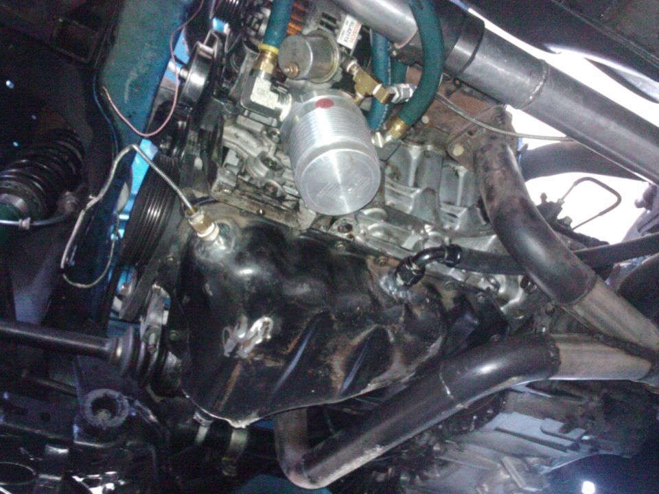 close-up of engine bay with custom turbo piping and oil cooler