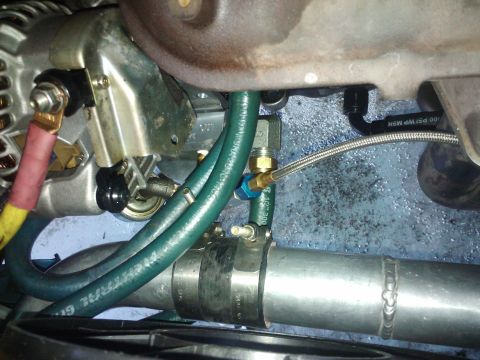 1995 Ford Probe - Close-up view of engine components, including hoses and metal piping.