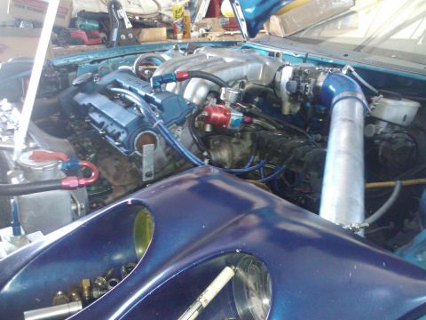 1995 Ford Probe - Engine bay modifications are visible, including blue valve covers and a custom intake system.