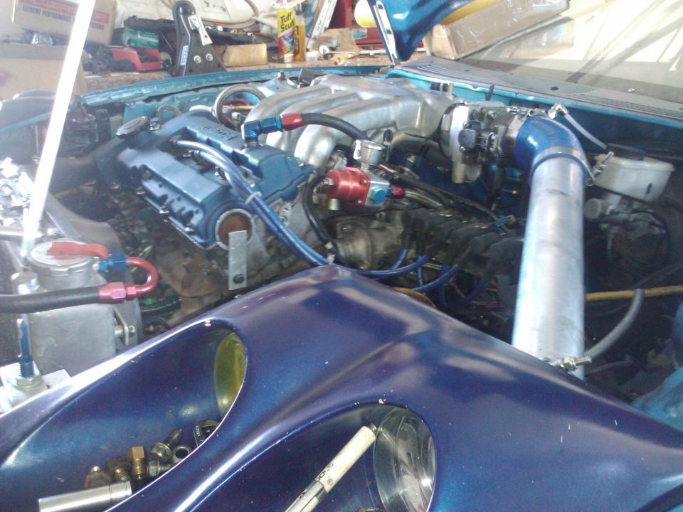 Blue engine bay with custom intake and blue valve covers