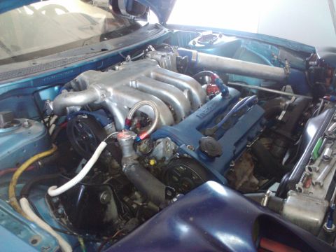 1995 Ford Probe - Close-up view of a modified engine bay, showing the V6 engine components and custom plumbing.