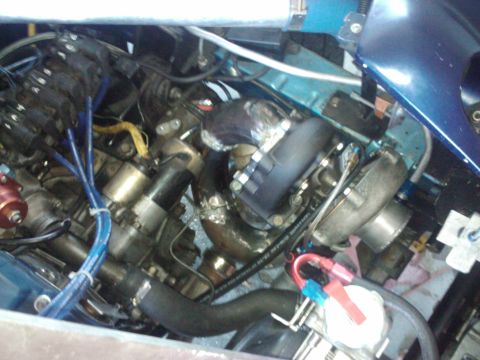 1995 Ford Probe - Close-up view of a modified engine bay a turbocharger and custom plumbing.