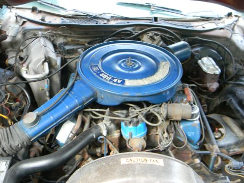 1979 Ford Ranchero - The engine bay of a 1979 Ford Ranchero features a prominent blue air cleaner assembly with '460-4V' visible.
