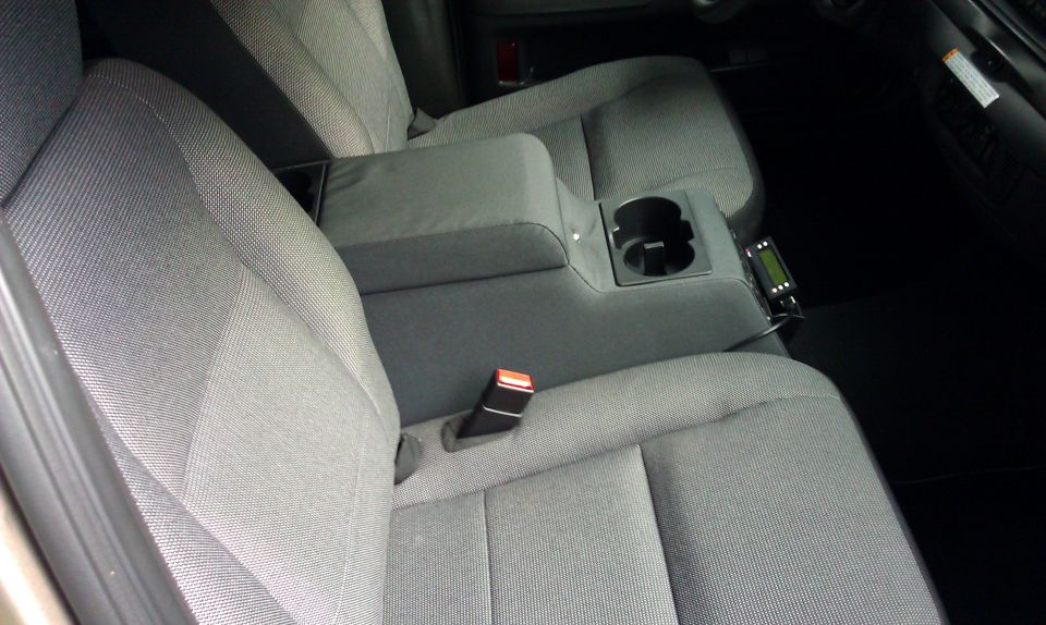 Gray fabric seats and center console with cup holder and small electronic device