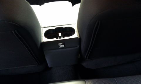 2007 Ford Crown Victoria - Aftermarket center console with cup holders and VIP branding installed between vehicle seats.