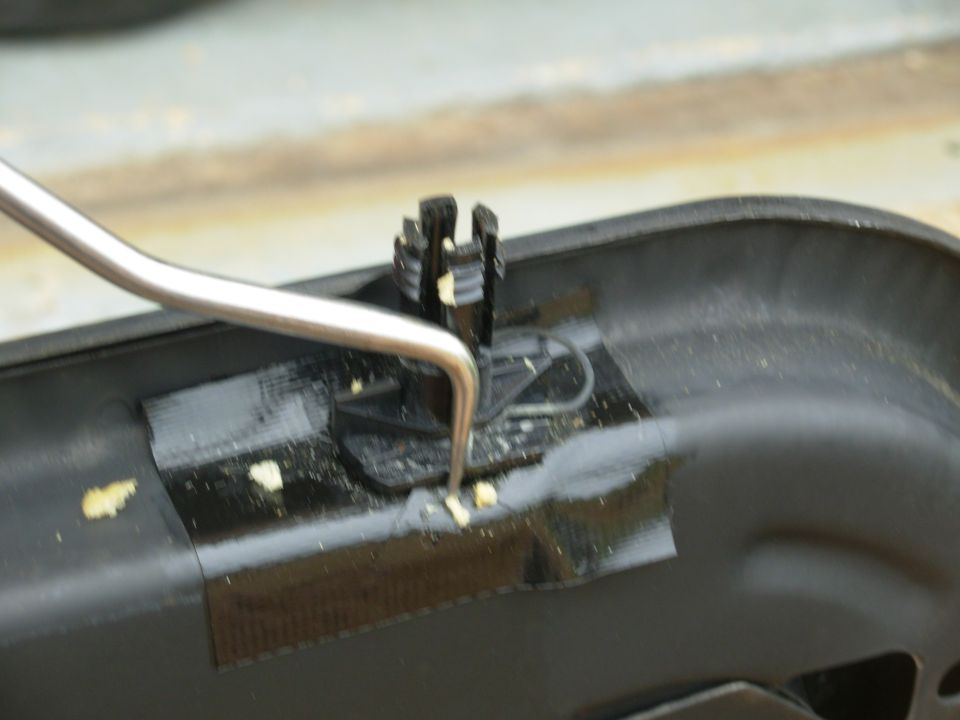 The clips can't be seen with the upholstery in place, but this what has to be done: the clips need to come out of their slots so the headrest can come out.