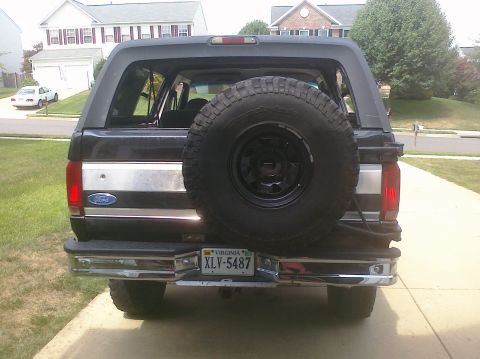 1995 Ford Bronco - Rear view of a black 1995 Ford Bronco, a spare tire mounted on the tailgate and a Virginia license plate.
