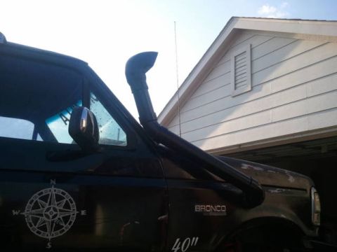 1995 Ford Bronco - A black SUV is equipped with a snorkel and a compass decal on its side.