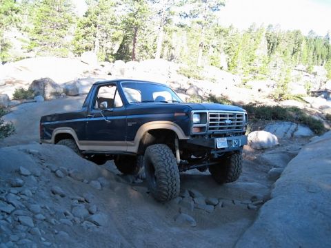 1986 Ford Bronco - This 1986 Ford Bronco navigates a challenging rocky trail, its off-road capabilities.