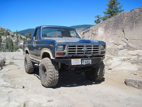 1986 Ford Bronco - This modified Ford Bronco navigates a challenging off-road environment.