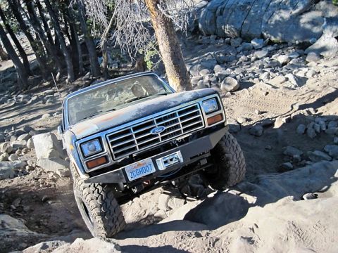 1986 Ford Bronco - This Ford Bronco navigates a challenging rocky trail, its grille and front end clearly visible.