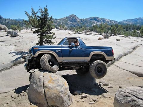 1986 Ford Bronco - This 1986 Ford Bronco is shown off-roading through a challenging rocky landscape.