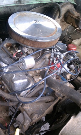 1978 Ford Bronco - Close-up view of an engine bay, showing various components like the air cleaner and distributor.