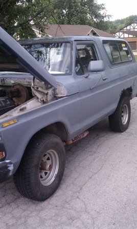 1978 Ford Bronco - This 1978 Ford Bronco is gray and has its hood open, showing some of the engine bay.