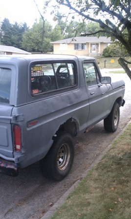 1978 Ford Bronco - This 1978 Ford Bronco is parked on a street with houses in the background.