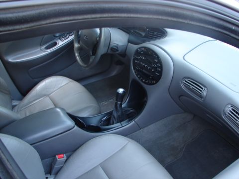 1992 Ford Taurus - The interior of a 1992 Ford Taurus shows its leather seats, dashboard, and center console.