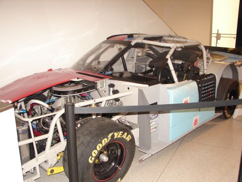1992 Ford Taurus - This race car shows its exposed engine and interior, with a red hood and Goodyear tires visible.