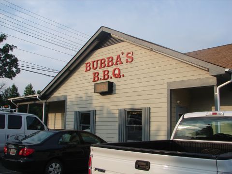 1992 Ford Taurus - Exterior view of Bubba's BBQ restaurant, with multiple vehicles parked in the lot.