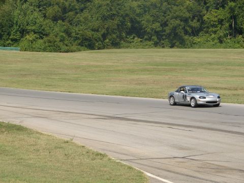 1992 Ford Taurus - A silver convertible sports car with racing decals is on the track.