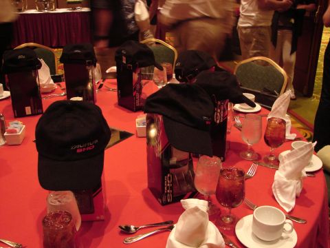 1992 Ford Taurus - Hats and drinks are set up on a red-covered table, likely for an event.