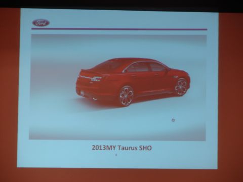 1992 Ford Taurus - A red sedan is presented with the text '2013MY Taurus SHO' below it.