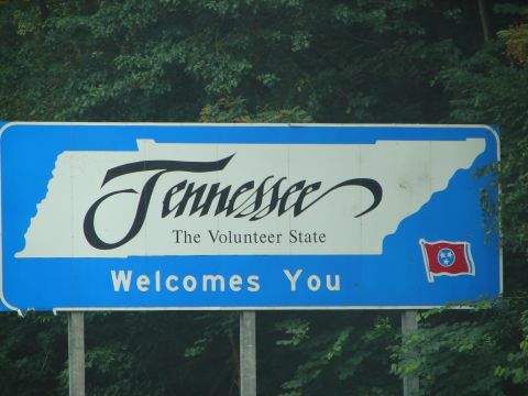 1992 Ford Taurus - Sign reads "Tennessee The Volunteer State Welcomes You" with the state flag.