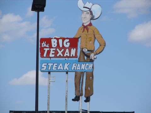 1992 Ford Taurus - Iconic roadside sign for The Big Texan Steak Ranch, famous for its 72oz steak challenge.